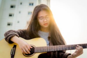girl playing guitar 300x200 - girl playing guitar