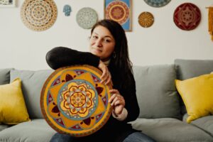 woman holding mandala art 300x200 - woman holding mandala art