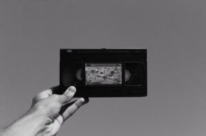 grayscale photo of a person holding a vhs tape 300x199 - grayscale photo of a person holding a vhs tape