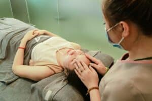a woman massaging her clients head 300x200 - a woman massaging her clients head