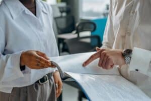 colleagues standing in white long sleeve shirts discussing and reading something 300x200 - colleagues standing in white long sleeve shirts discussing and reading something