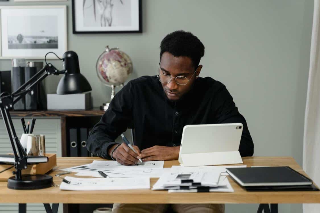 man doing paperwork - How to Improve Your Law Firm's Bookkeeping Efficiency