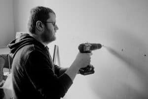 man drilling wall in house 300x200 - man drilling wall in house.jpg