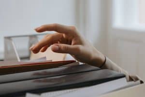 a person reaching out for a file 300x201 - a person reaching out for a file