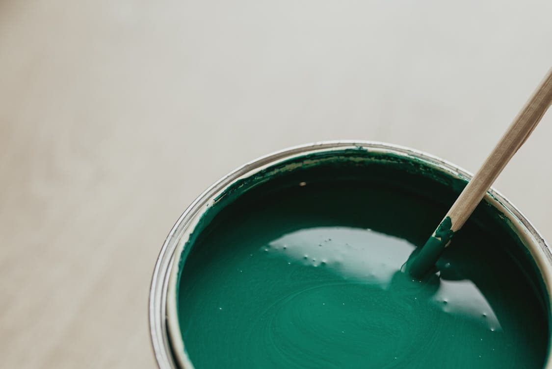 Close Up Photo of a Can with Green Paint - How to Prep a Garage Floor Before Epoxy Application