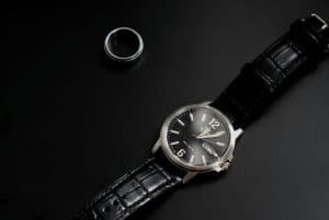 a ring and luxury watch on black surface 300x201 - a ring and luxury watch on black surface