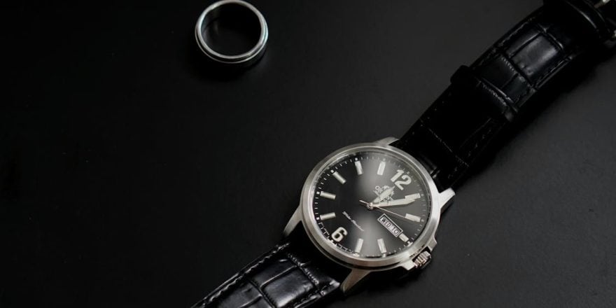 a ring and luxury watch on black surface 880x440 - Why Tungsten Rings Are Ideal for Active Lifestyles