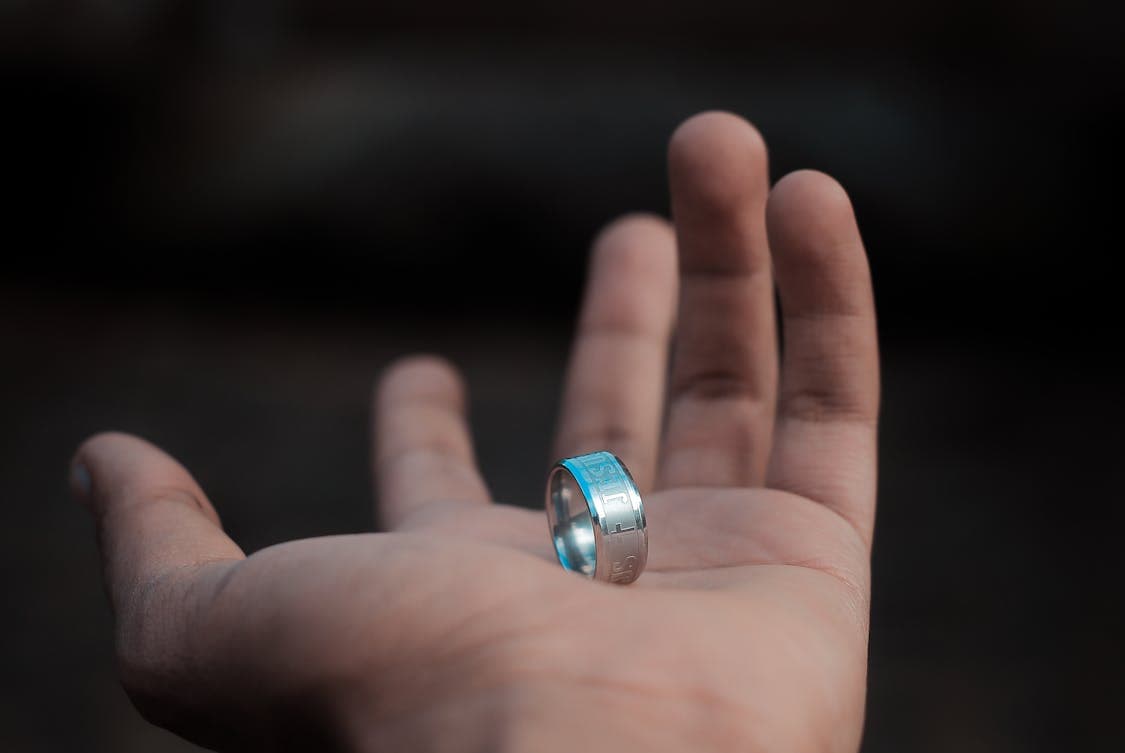 silver colored tungsten ring on hands 1 - Why Tungsten Rings Are Ideal for Active Lifestyles